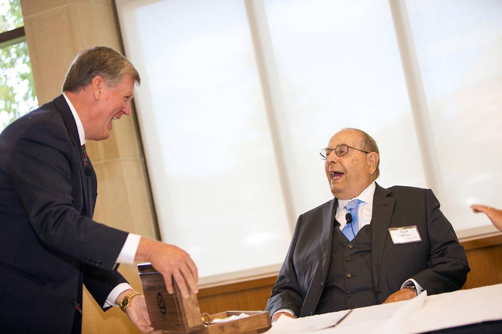 President Emeritus Tom Haas presenting Richard DeVos with a gavel.